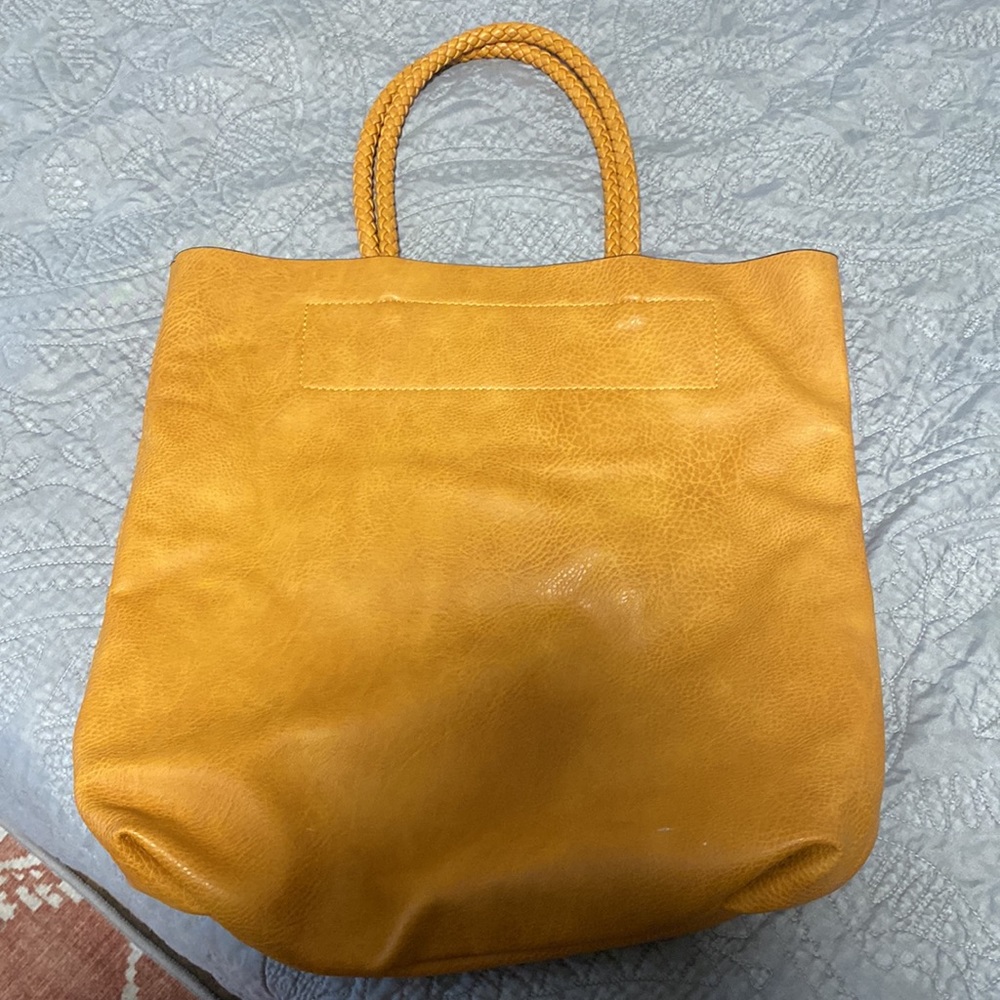 Brown leather tote bag with braided straps